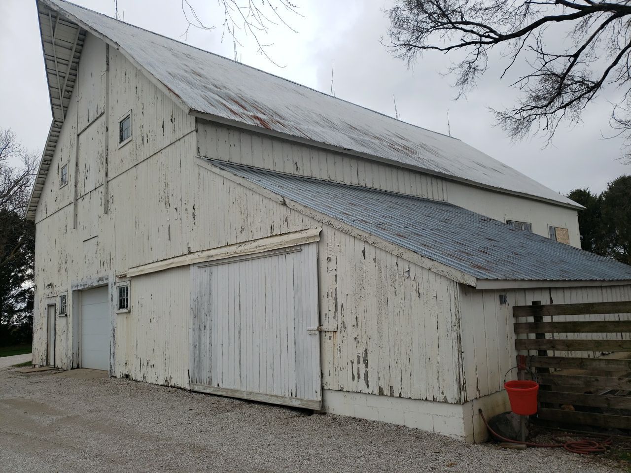 Horse Barn Restoration with Board and Batten Siding Before Picture
