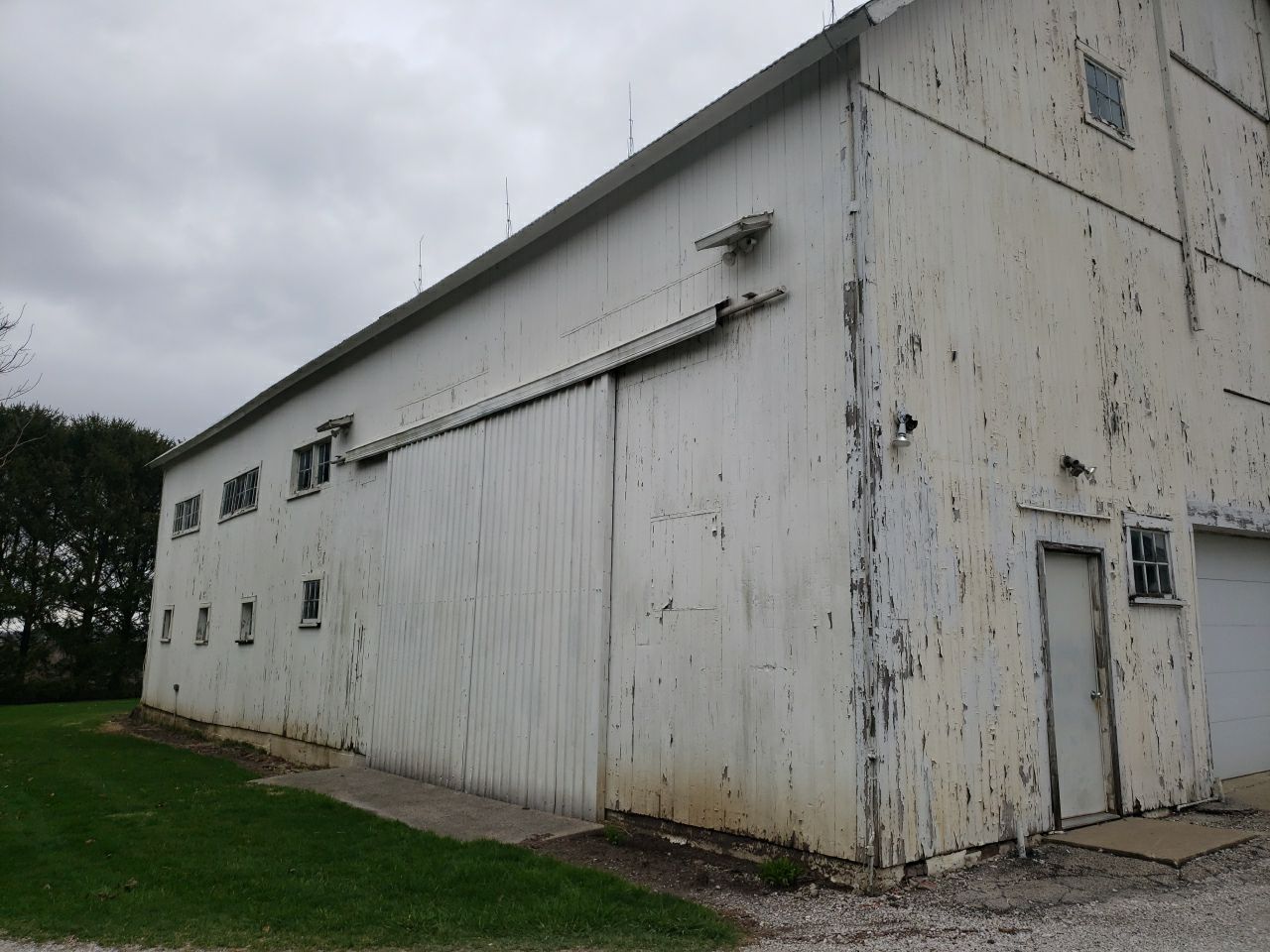 Horse Barn Restoration with Board and Batten Siding Before Picture
